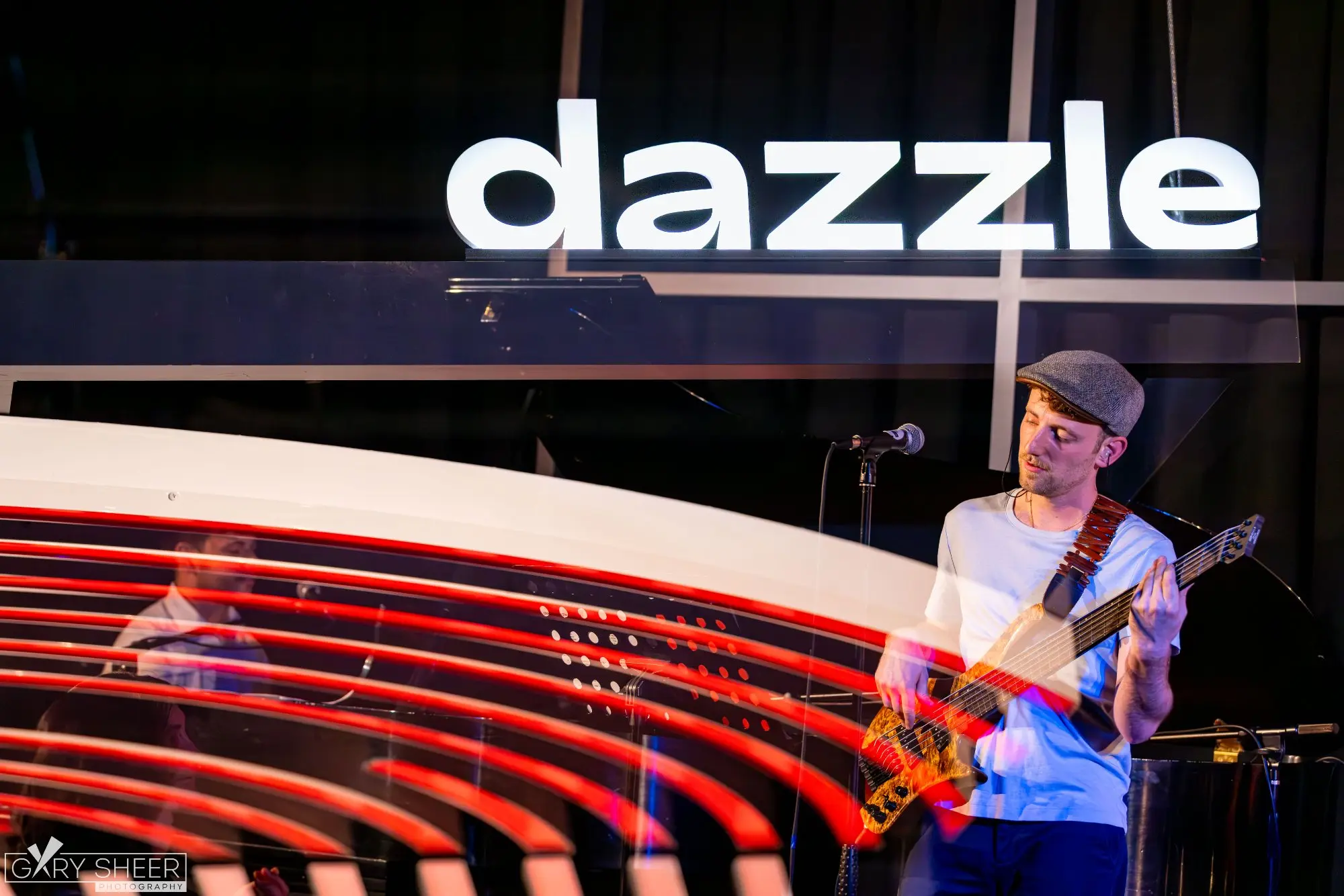 Jordan Lovinger performing under the Dazzle sign, Denver's premier jazz club
