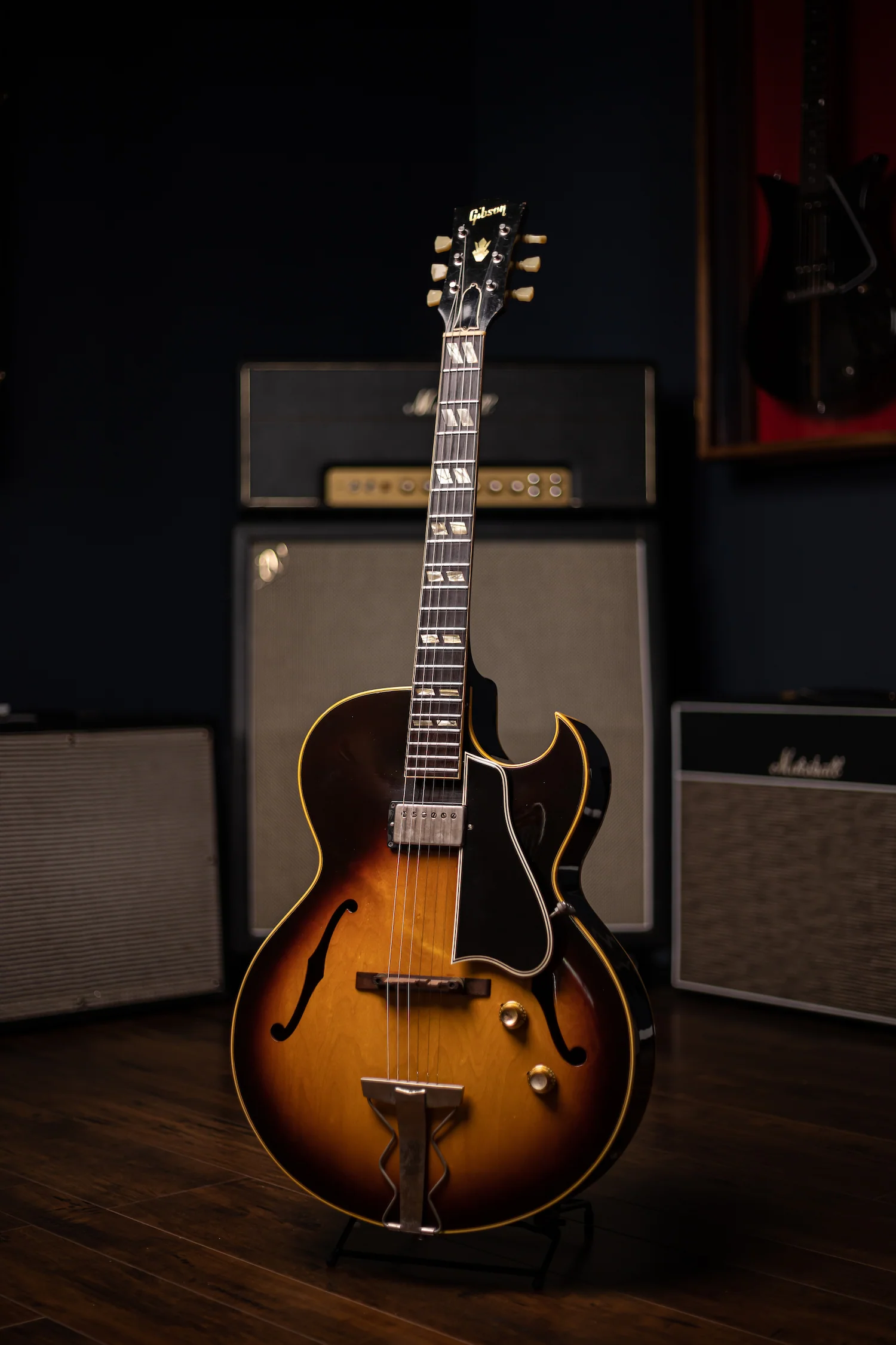 Gibson ES-175 archtop jazz guitar in front of vintage Fender amplifier