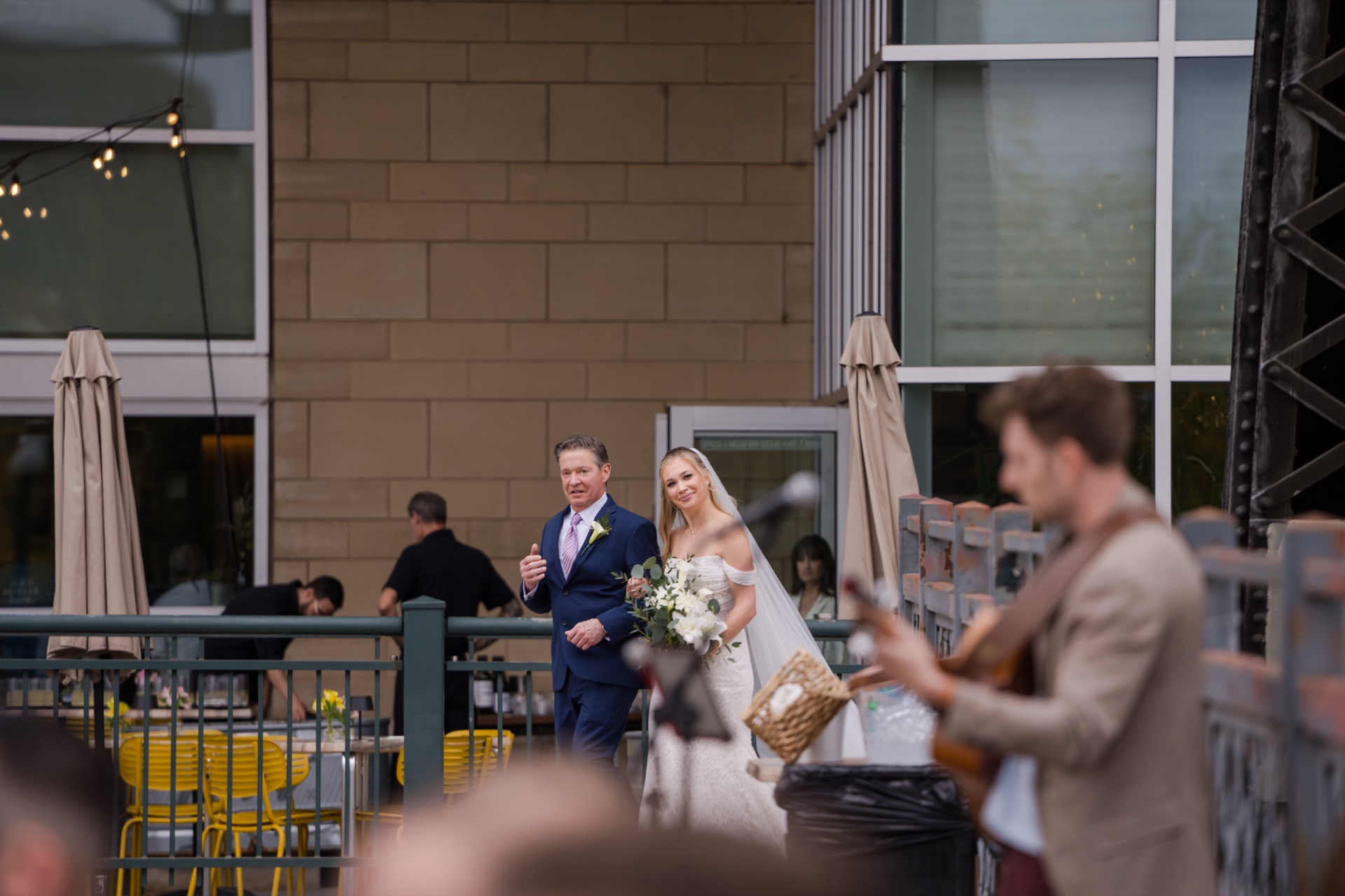 Bride and father walking down the aisle while acoustic guitarist Jordan Lovinger performs live at Coohills wedding in Denver